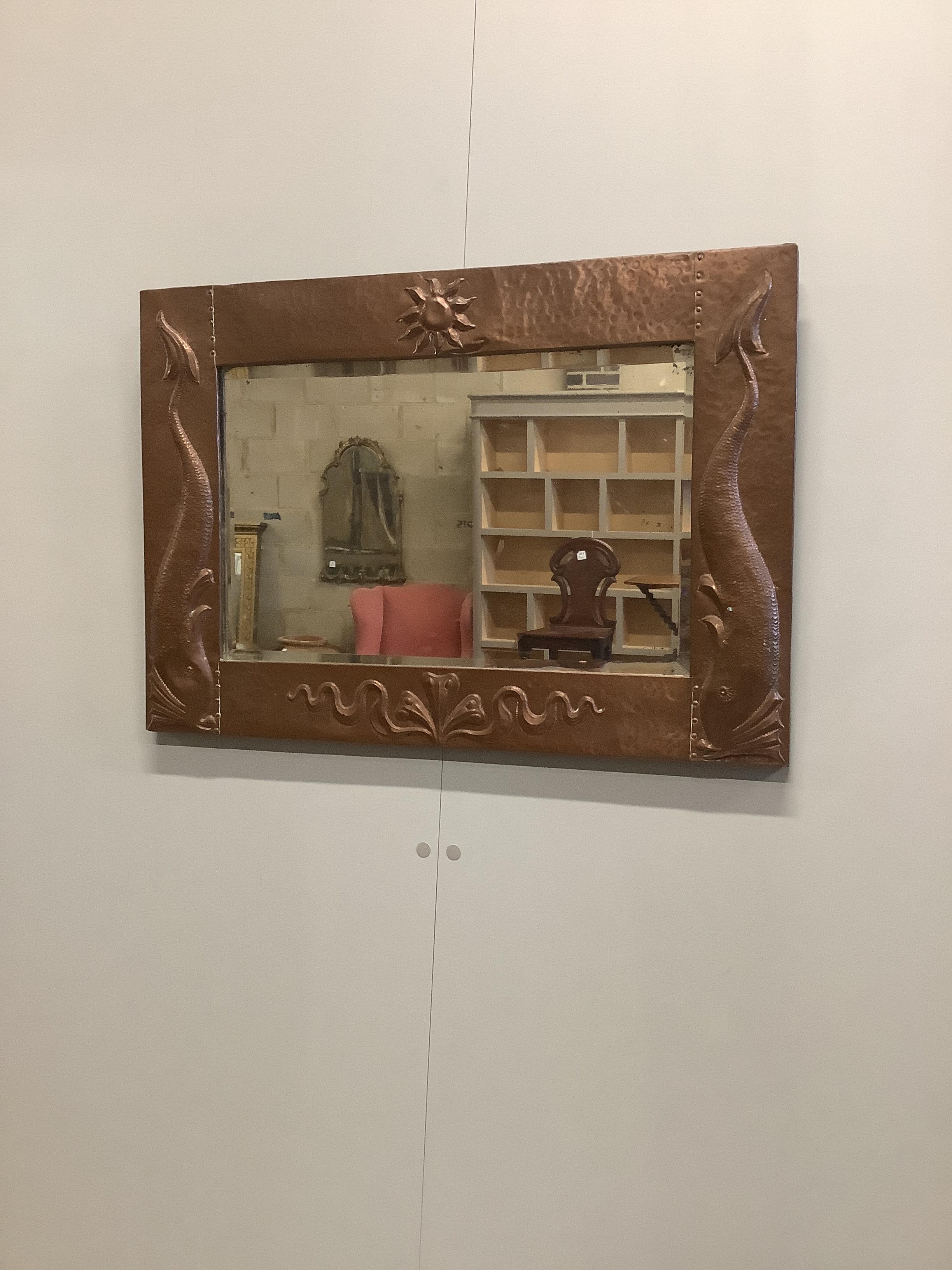 An Arts & Crafts Newlyn style embossed copper rectangular wall mirror, width 67cm, height 47cm